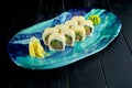 Fresh, Japanese sushi rolls with avocado, cucumber and ÃÂµÃÂ³ÃâÃâ, served in a plate with wasabi and ginger on a dark background. Royalty Free Stock Photo